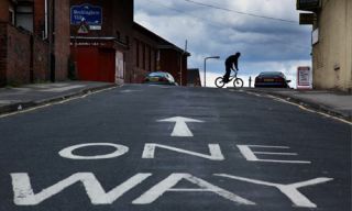 When operating a bicycle on a one-way street with two or more traffic lanes, you may ride as close to the: