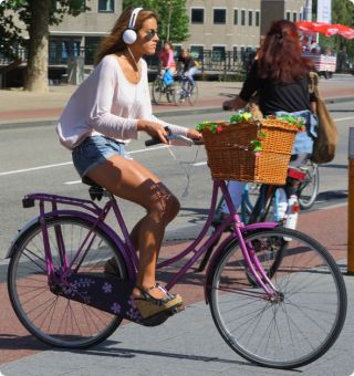 When is it ok to ride a bicycle while wearing headphones?