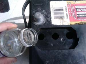 When topping up your battery with distilled water, you should fill: