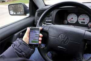 When driving without a hands-free device and your mobile phone rings, you should: