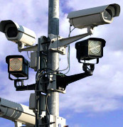 You are approaching an intersection that has a red light camera. The lights turn yellow when you are too close to stop safely. The lights go red as you get to the other side of the intersection. Will you receive a penalty notice?