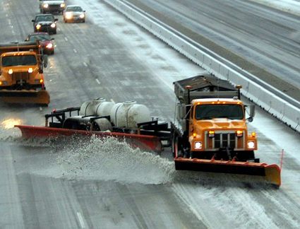 When approaching a snow plow, what should you do?
