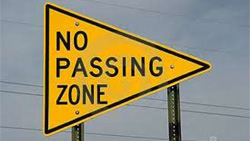You must not pass on two-lane highways in all of the following situations EXCEPT: