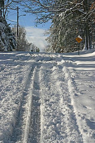 What should you do when approaching a snowy or icy hill?