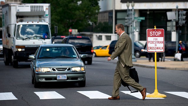 When a vehicle ahead of you stops to let a pedestrian pass in front of you, you should: