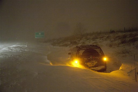 If you are stranded in a snowstorm, what should you NOT do?