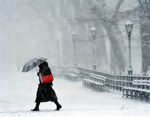 If caught in a snow storm and you have to walk in the street, what should you do if you must walk?