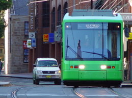 You drive up to a Light Rail vehicle that has just stopped at a tram stop. What is the most important thing you should do?