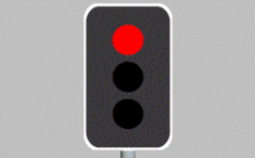 As you approach an intersection with traffic lights, the yellow light turns to red. You must: