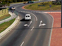 What may the van in the left lane in this roundabout do?