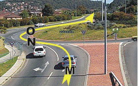 You are in the right hand lane and are planning to go straight ahead through this roundabout. When should you signal left to exit the roundabout?