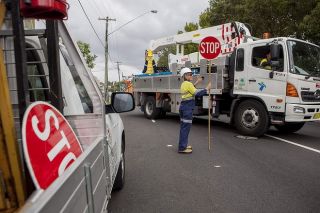 If you are driving towards a road works zone and a traffic controller displays a stop sign you must: