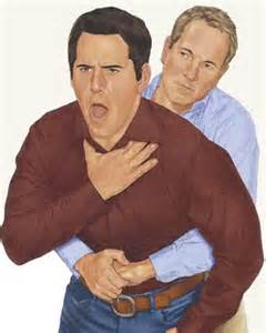 Before administering the Heimlich maneuver, where on the victimâ€™s abdomen should you position your hands?