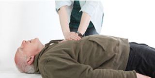What should you do if the person next to you suddenly makes a strange sound then falls to the ground unconscious, lying stiffly on their back for a few seconds, before beginning to jerk their arms and legs violently?