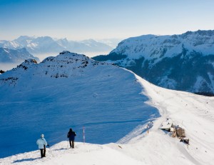 You are a member of a search party and have found the missing person, who has been lost overnight in the mountains in winter. The person is inadequately dressed and very wet. What should you do?