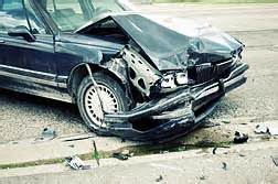 At the scene of an accident, what should you do first to your vehicle?