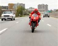 To stop or slow your motorcycle down, you should: