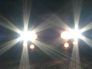 If you are driving at night with your vehicle headlights on high beam, legally when MUST you dip them?