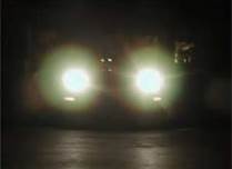 When driving at night with your full beam headlights on and a vehicle is overtaking you, you should:
