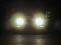 How can you deal with an oncoming vehicle that keeps its high beams on?