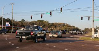 If you have a green light, but traffic is backed up into the intersection, what should you do?