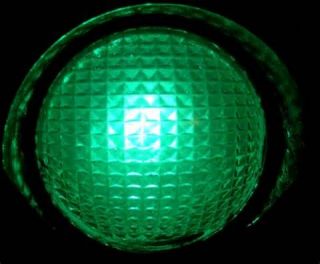 What should you do when a traffic signal light turns green?