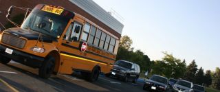A school bus in picking up or dropping off children, you must: