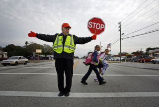When should you obey instructions from school crossing guards?