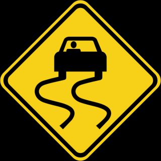 Name some places where you are likely to find slippery spots on the road.