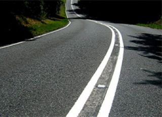 A solid white line indicates what part of the traffic lane on a road?