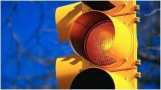 You are approaching an intersection where the traffic light has changed to yellow: