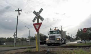 What is the correct action to take when at a railroad crossing that does not have signals?
