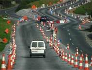 When approaching roadworks on a motorway, one should: