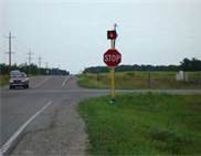 Where should you stop at an intersection where there is a stop sign, but no stop line or crosswalk?