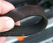 When checking an air compressor belt, you should look for:
