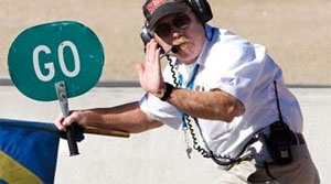 If you are waiting to enter a track from a spin out and you see a corner worker hold up three fingers, what does this mean?