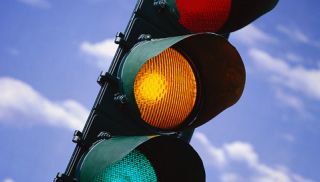 If you have already started through an intersection when the signal light changes, you must: