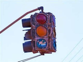 You approach an intersection with a set of traffic signals. The signals are blank, what should you do?