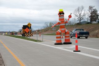 When approaching or driving through a work zone, you must NOT: