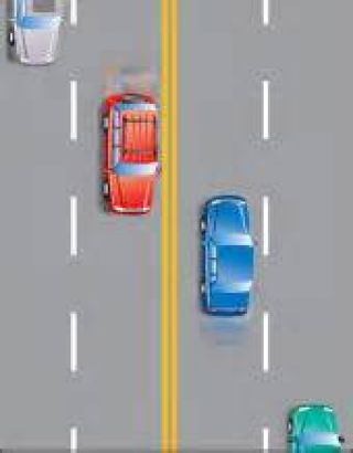 When there are four or more lanes with traffic moving in opposite directions, two solid yellow lines mark the: