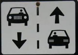 Which of the following situations prohibit you from driving on the left half of the road?