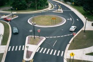 A roundabout is a circular intersection where vehicles travel around a center island in _________ direction.