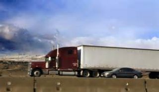 When passing a large vehicle, do not pull back in front of the truck until you can see its: