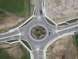 In a roundabout intersection, drivers must _________, whether they need to make a right turn, a left turn, a U-turn or continue forward.