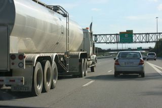 When a truck is trying to pass your vehicle, you can help the truck driver by: