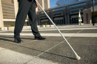 A pedestrian using a white or white cane tipped with red is usually: