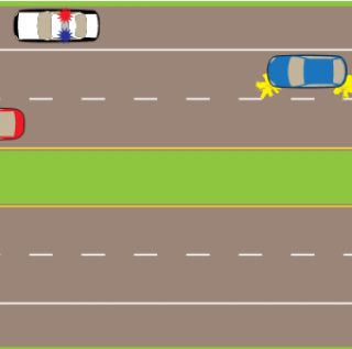 You are travelling along a four lane highway. You see an emergency vehicle pulled over with its lights flashing ahead. Which of the following is true?