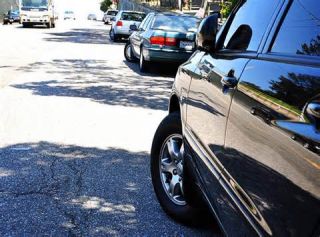 You have parked next to the curb facing up hill. Which way should you point your front wheels to stop your car from rolling if your brakes should fail?