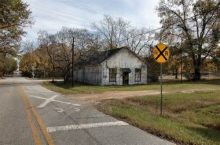 If a railroad grade crossing has no warning devices or only a cross buck sign, you should: