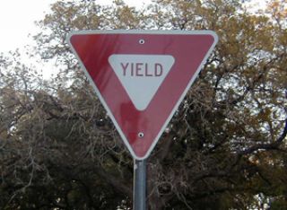 What does a Yield sign mean?